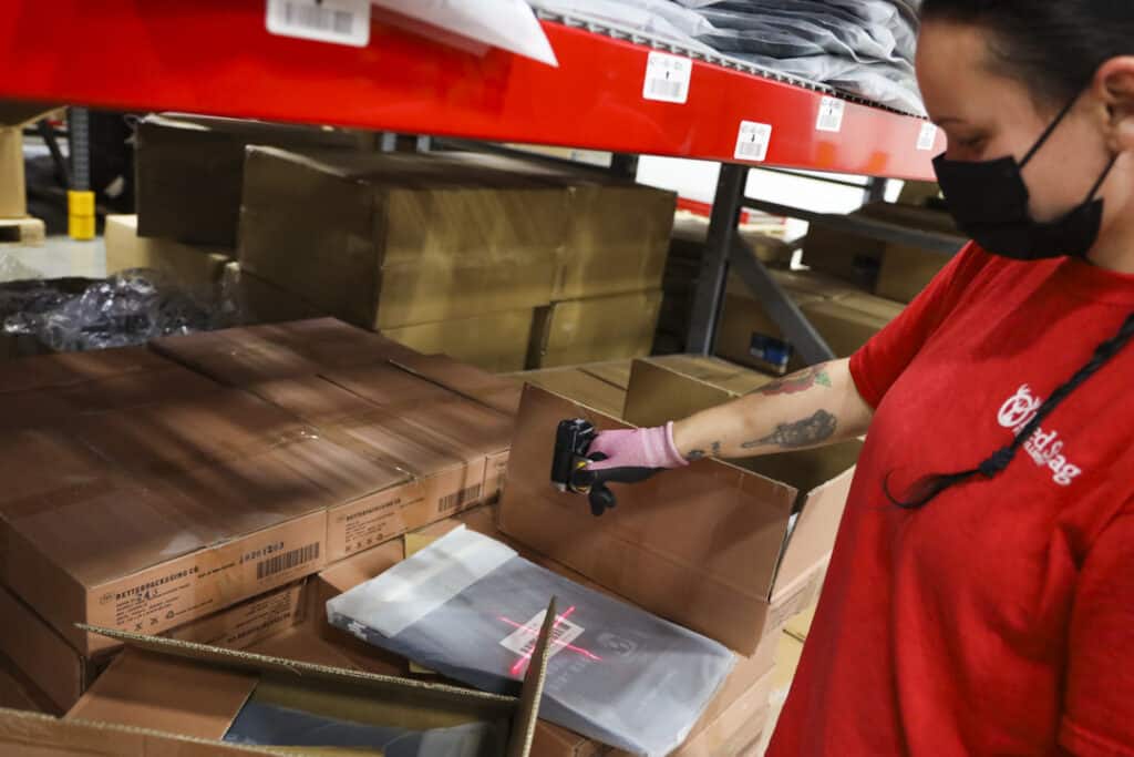 warehouse employee scans a barcode with a handheld scanner