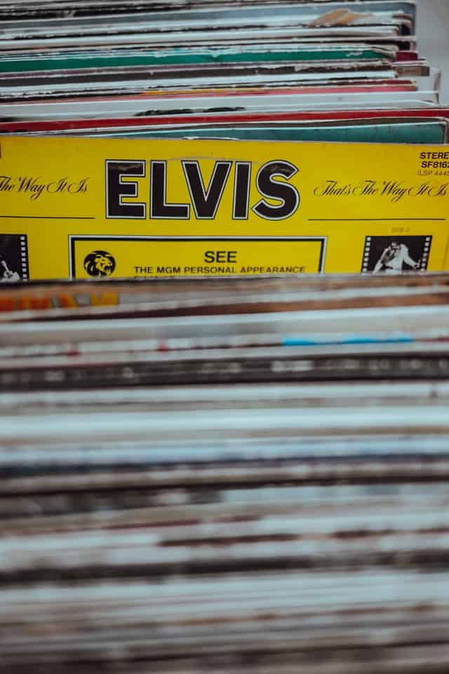 Elvis among a stack of vinyl highlighting the trend of the King's return