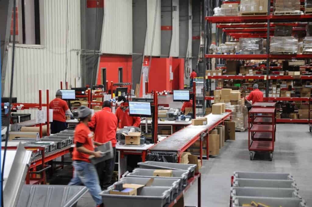 warehouse associates go about their regular tasks