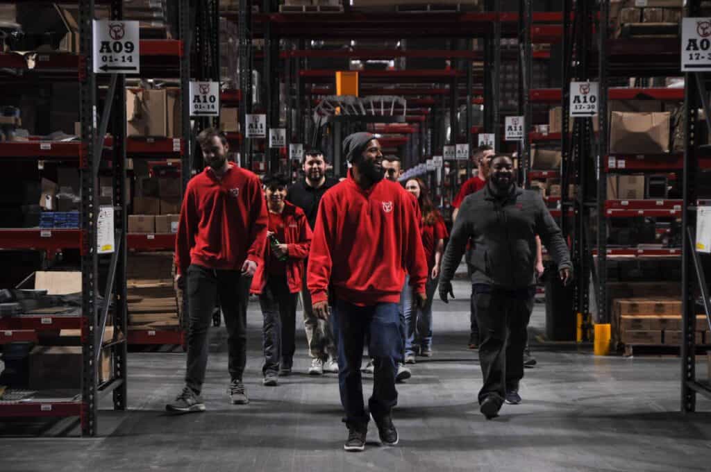 Red Stag team walking through warehouse storage